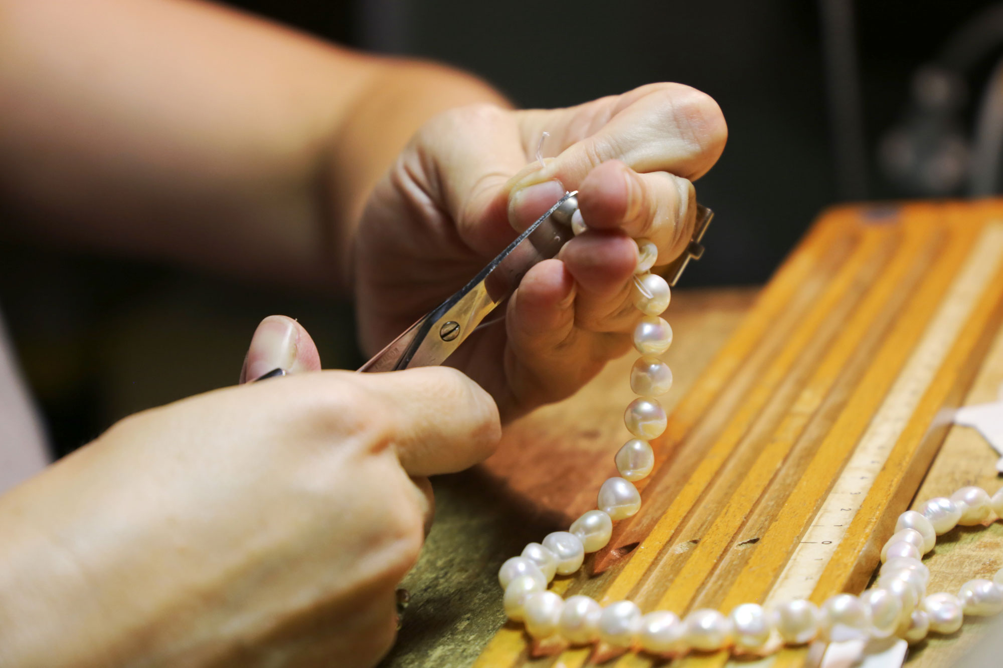 Jeweler Restringing a Pearl Necklace